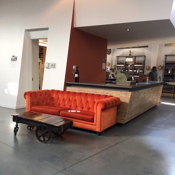 Sandhill Estate Winery - orange couch and coffee table - Wineries Near Me - Kelowna, British Columbia Sandhill Estate Winery - orange couch and coffee table - Wineries Near Me - Kelowna, British Columbia
