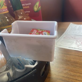Denny's - Nasty dirt and black goo on jelly packet holder - American Near Me - Tucson, Arizona