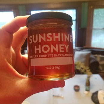 Sunshine Honey - a hand holding a jar of honey - Pest Control Near Me - Ventura, California