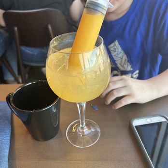 Hash Kitchen - Sparklers (glitter orange juice w flavored tonic) - New American Near Me - Gilbert, Arizona