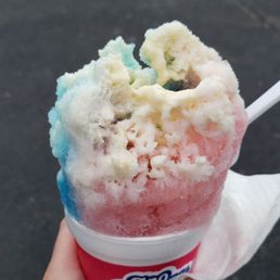 a hand holding a cup of ice cream a hand holding a cup of ice cream