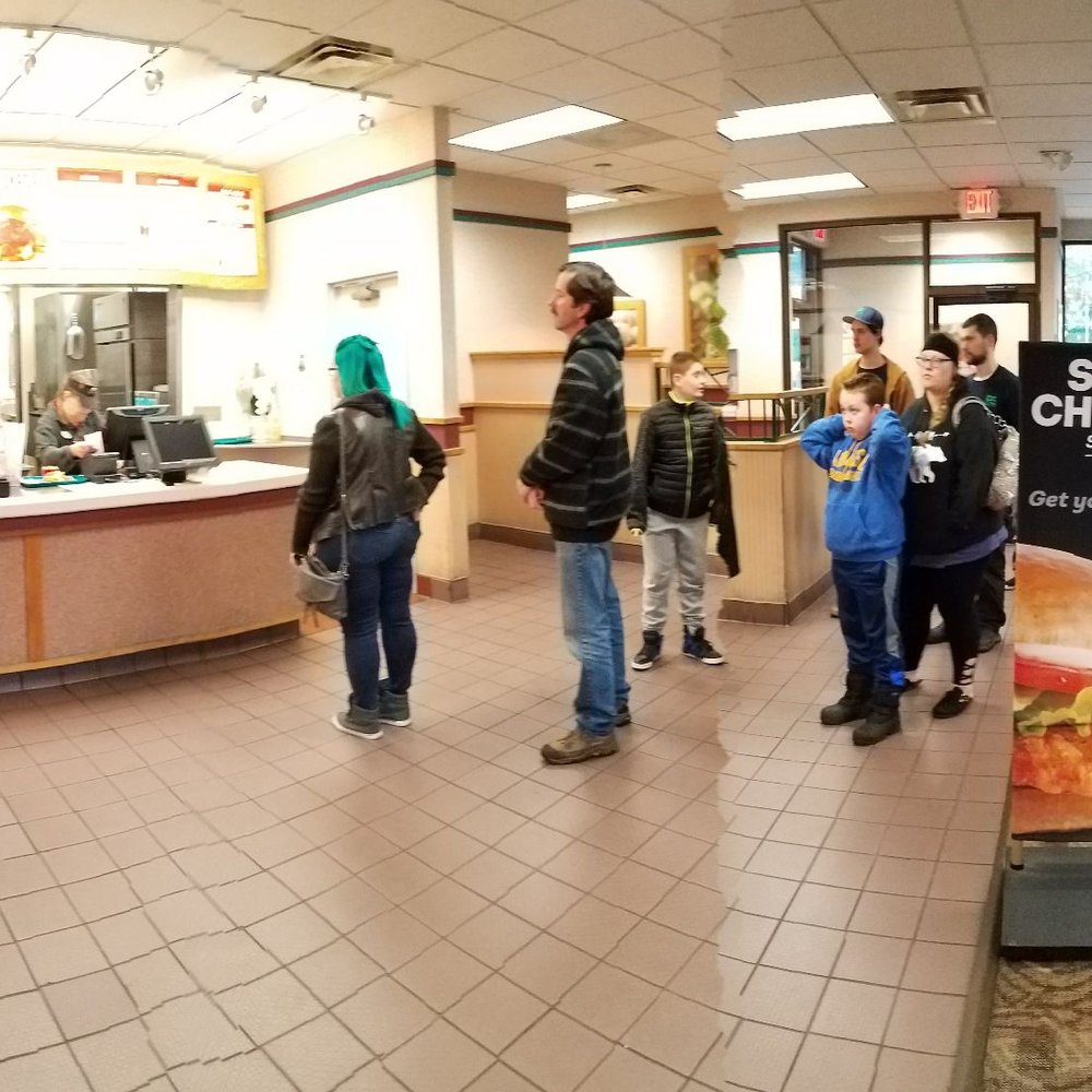 a group of people in a restaurant a group of people in a restaurant
