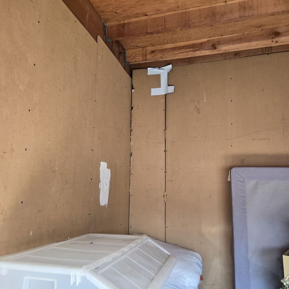 The plyboard is ripped off the wall already, you see the tape on top and the nail marks on the board ripped off