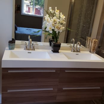 JW Construction - a bathroom with two sinks and a shower - General Contractors Near Me