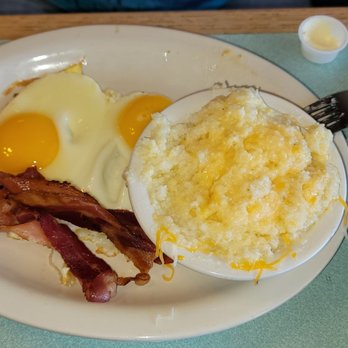 Country Skillet - Grits with a tiny bit of cheese added for an upcharge, among with eggs and some scraggly bacon. - Diners Near Me - Clearwater, Florida Country Skillet - Grits with a tiny bit of cheese added for an upcharge, among with eggs and some scraggly bacon. - Diners Near Me - Clearwater, Florida