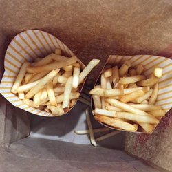 McDonald's - 2 large fry orders AFTER talking with the pictured manager about the half full fries. This was her 2nd attempt.
