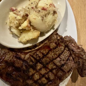 Five D Cattle - Cowboy ribeye and potatoes It was so big it was hanging of the side of the plate! Side salad not pictured but was fresh! - Steakhouses Near Me - Avinger, Texas Five D Cattle - Cowboy ribeye and potatoes It was so big it was hanging of the side of the plate! Side salad not pictured but was fresh! - Steakhouses Near Me - Avinger, Texas