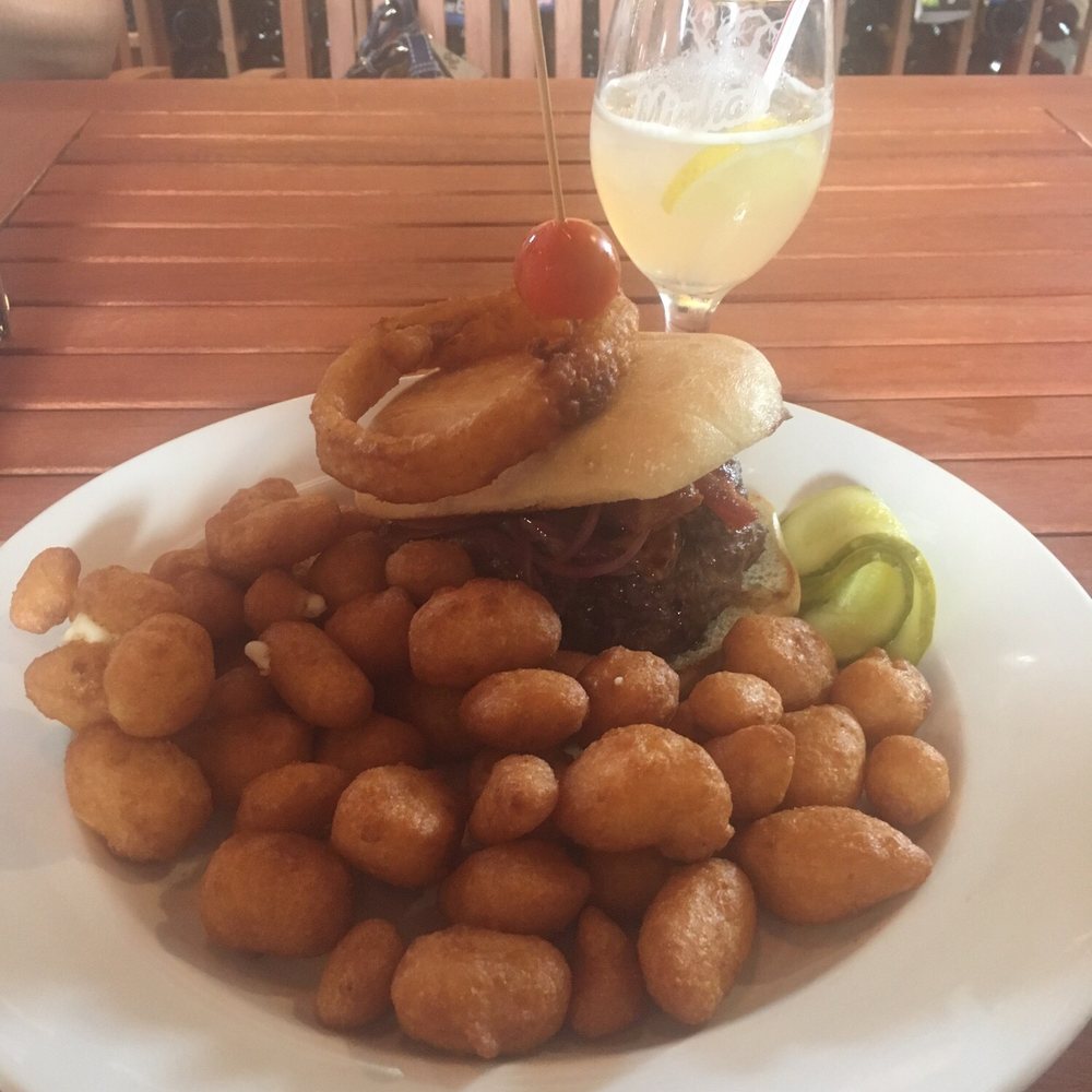 Minhas Kitchen - Venison burger with curds. Hard lemonade concoction in the background. - New American Near Me - Monroe, Wisconsin Minhas Kitchen - Venison burger with curds. Hard lemonade concoction in the background. - New American Near Me - Monroe, Wisconsin