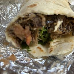 Barbacoa burrito with grilled onions, salsa, cilantro, and lime Barbacoa burrito with grilled onions, salsa, cilantro, and lime