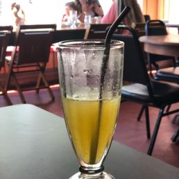 a glass of juice on a table a glass of juice on a table