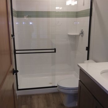 Hilton Glass & Door - Sliding shower door with clear glass and black metal. Hilton Glass and Door 208-263-3322 - Windows Installation Near Me - Sandpoint, Idaho Hilton Glass & Door - Sliding shower door with clear glass and black metal. Hilton Glass and Door 208-263-3322 - Windows Installation Near Me - Sandpoint, Idaho