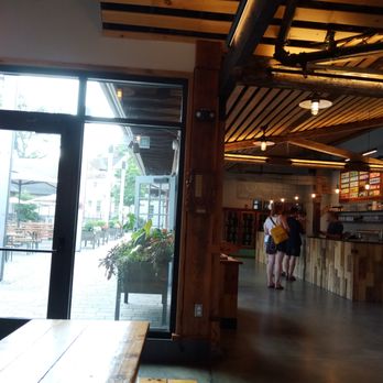 Notch Brewing - Interior of Notch Brewing (right) and outside bier garden (left) - Breweries Near Me - Brighton, Massachusetts