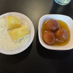 Rice pudding with fresh pineapple and the donut like dessert with honey syrup. Delicious!