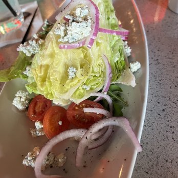 Ruth's Chris Steak House - Wedge salad minus the back. I added red onions and tomatoes. Dressing on the side. - Steakhouses Near Me - Lake Mary, Florida Ruth's Chris Steak House - Wedge salad minus the back. I added red onions and tomatoes. Dressing on the side. - Steakhouses Near Me - Lake Mary, Florida