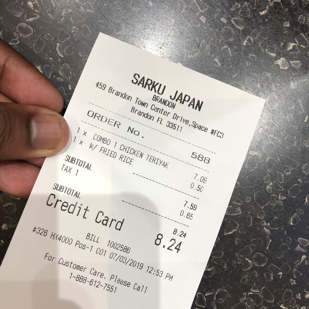 a hand holding a receipt