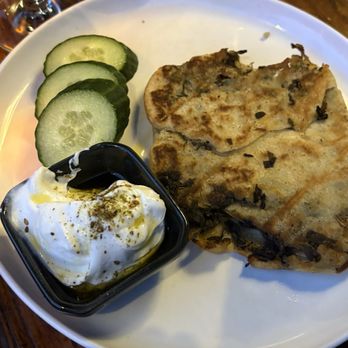 Qanoon - Palestinian Zara's bread with a side of cucumber and garlic labaneh ($20) - Middle Eastern Near Me - New York, New York