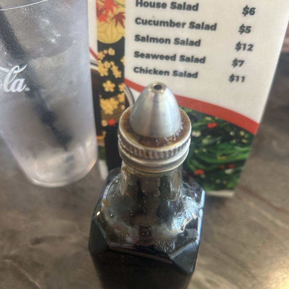 Dirty bottle soy sauce bottle on sticky table Dirty bottle soy sauce bottle on sticky table
