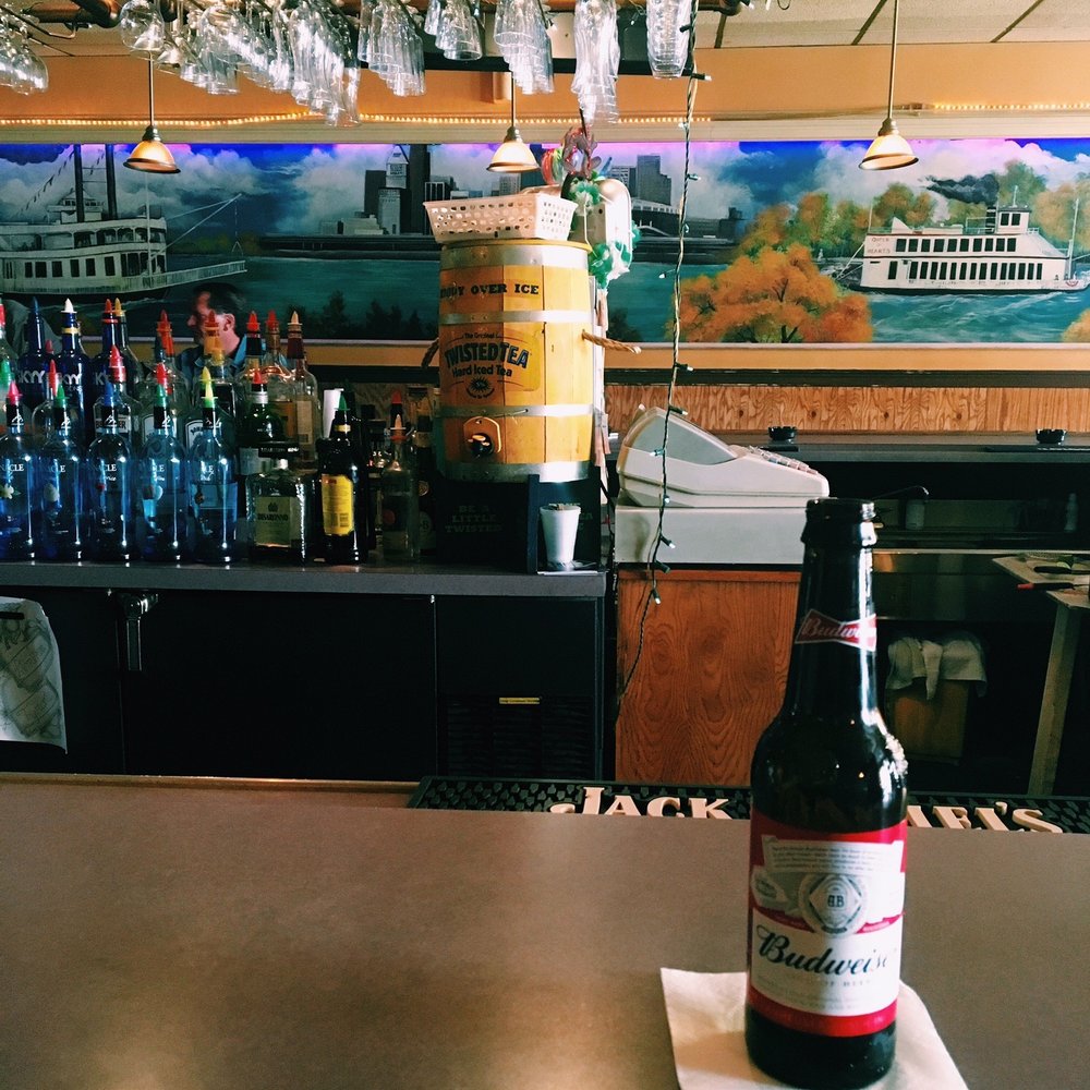 Huddle's Cafe - a bottle of wine on a table - Dive Bars Near Me - Newport, Kentucky