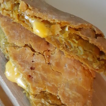 Jamaican Flavors - Close up of the curry chicken patty with cheese. - Bakeries Near Me - Jamaica, New York