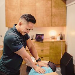 Village Fitness & Physical Therapy - San Marino - Dr. Justin Lee, PT DPT working hands on with a patient