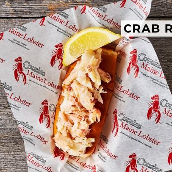 Cousins Maine Lobster - Austin - a lobster roll with a slice of lemon - Seafood Near Me Cousins Maine Lobster - Austin - a lobster roll with a slice of lemon - Seafood Near Me
