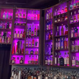 a wall of liquor bottles in a bar a wall of liquor bottles in a bar