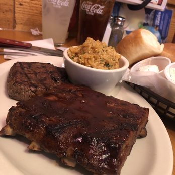 Texas Roadhouse - Streak and ribs seasoned rice. Basket of warm rolls in the background. - Steakhouses Near Me - Oceanside, California Texas Roadhouse - Streak and ribs seasoned rice. Basket of warm rolls in the background. - Steakhouses Near Me - Oceanside, California