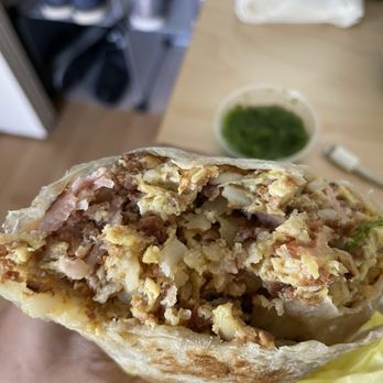Curbgrill - a person holding a breakfast burrito - Breakfast & Brunch Near Me - Montrose , California