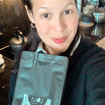 Coffee Company Express - a woman holding a bag of coffee - Coffee & Tea Near Me