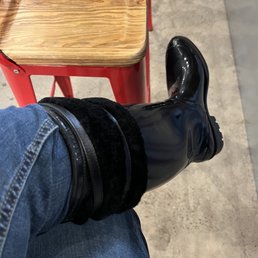 a person's legs wearing black boots