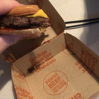 McDonald's - a hand holding a half eaten hamburger - Burgers Near Me - Sumner, Washington McDonald's - a hand holding a half eaten hamburger - Burgers Near Me - Sumner, Washington