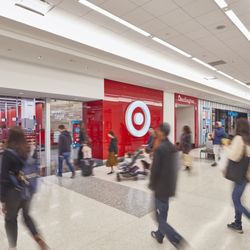 Kings Plaza Shopping Center - Shoppers walk past the first-level Target entrance near Burlington and Primark at Kings Plaza.