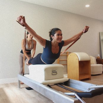 Ascend Pilates - Founder Christie Wang gives hands on instruction to student. - Pilates Near Me - San Diego, California Ascend Pilates - Founder Christie Wang gives hands on instruction to student. - Pilates Near Me - San Diego, California