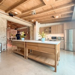 ima Members Lounge - Bright, modern catering kitchen with dual islands and stainless steel appliances at the ima event rental space in West Los Angeles.