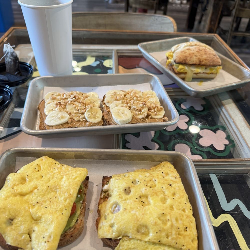 Avocado toast topped with scrambled egg, peanut butter and banana toast and breakfast egg sandwich