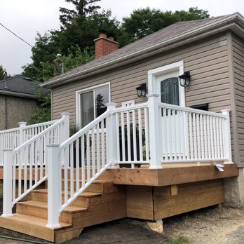 Kinnaird Contracting - a porch with a white railing - General Contractors Near Me Kinnaird Contracting - a porch with a white railing - General Contractors Near Me