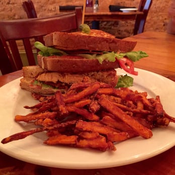 Grits Cafe - Blackened salmon sandwich with bacon, lettuce, tomato and spicy tarter sauce on grilled wheat berry bread with sweet potato fries. - Southern Near Me - Forsyth, Georgia