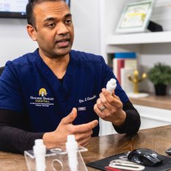 Shore Smiles Dental, PC - Dr. Jigar Gandhi from Shore Smiles Dental explaining treatment to a patient
