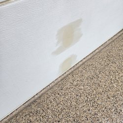 Phoenician Garage Door & Repair - They tried to clean oil spot and it made it worse. The paint on the garage door is so old, it created the issue.