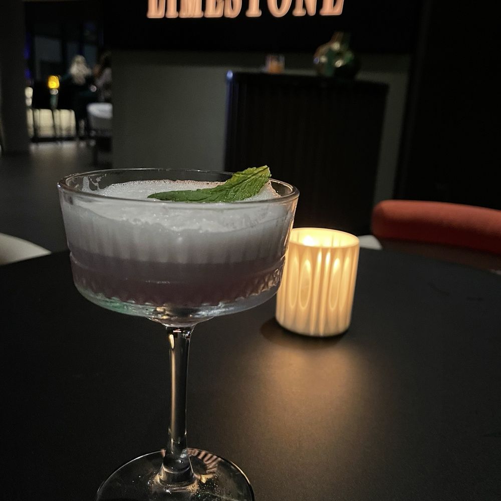 Limestone Rooftop - Purple Haze (Empress gin, basil, lemon, egg white foam) - Lounges Near Me - Austin, Texas