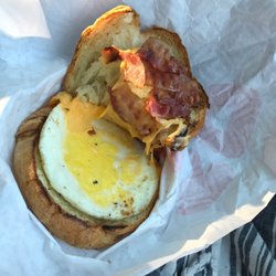 Dunkin' - Two slices of bacon. Actually one and half slices of bacon on a breakfast croissant... yea. We paid extra and it's on our receipt.
