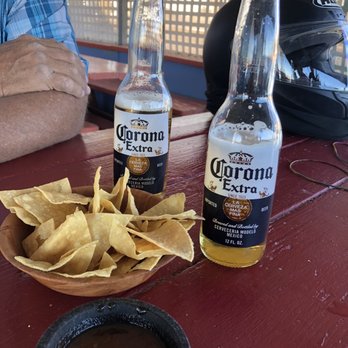 Alamo Restaurant - a man sitting at a table with a bowl of chips and a bottle of corona beer - Mexican Near Me - Thermal, California