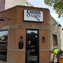 Cigar Oasis - New sign being installed.
