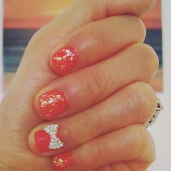VIP Nails - Coral with sparkles that shimmers like the sunset along with a cute bow jewel on the nail of my ring finger - Nail Salons Near Me - San Diego, California