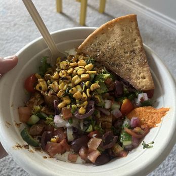 CAVA - Half splendid greens, half basmati rice, grilled chicken, Zike, red hummus, feta sauce, Greek dressing, olives, roasted corn, pita chips!!! - Mediterranean Near Me - Flower Mound, Texas