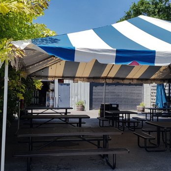 Calusa Brewing - a tent with tables and benches - Beer Bar Near Me - Sarasota, Florida Calusa Brewing - a tent with tables and benches - Beer Bar Near Me - Sarasota, Florida