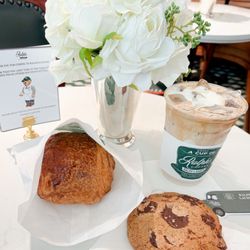 Iced latte with cold foam, chocolate croissant and chocolate cookie