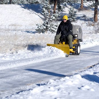 Green Machine - a man driving a snow plow down a snowy road - Lawn Services Near Me - Greeley, Colorado Green Machine - a man driving a snow plow down a snowy road - Lawn Services Near Me - Greeley, Colorado