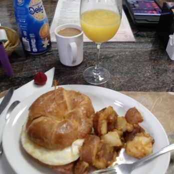 Red Rooster - Breakfast sandwich on a wonderful croissant. And great mimosa. - Diners Near Me - Marco Island, Florida Red Rooster - Breakfast sandwich on a wonderful croissant. And great mimosa. - Diners Near Me - Marco Island, Florida