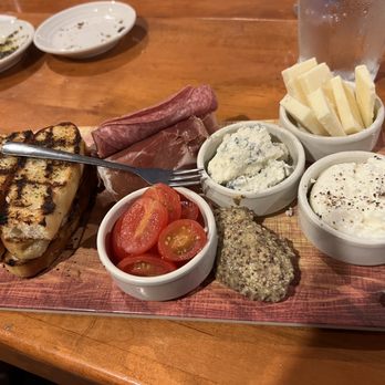 Carrabba's Italian Grill - Happy hour charcuterie board with tomatoes instead of olives because they were out of olives. - Italian Near Me - Orlando, Florida Carrabba's Italian Grill - Happy hour charcuterie board with tomatoes instead of olives because they were out of olives. - Italian Near Me - Orlando, Florida